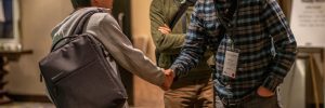 William Frank shaking hands with unknown at Annual Meeting