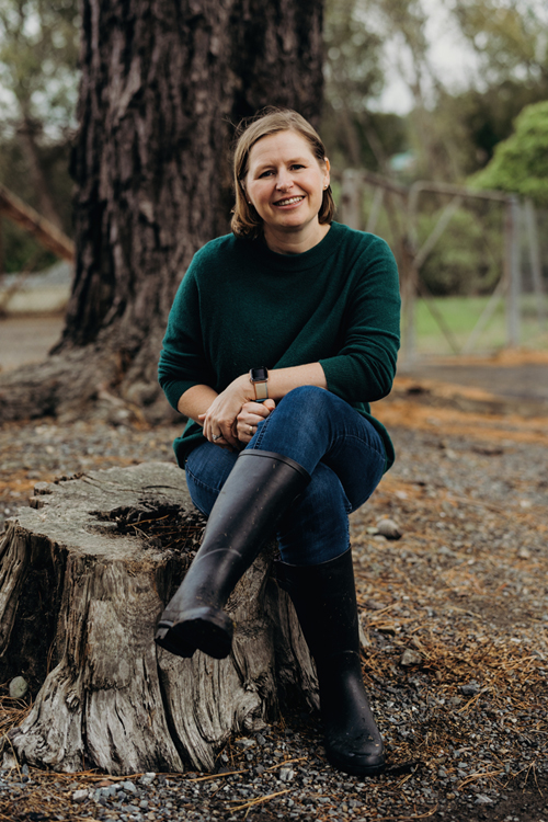 Natalie Balfour sitting on tree stump