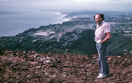 Paul Spudich standing on hillside