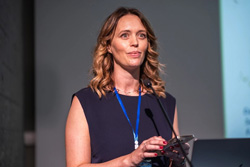 Helen Crowley speaking at podium