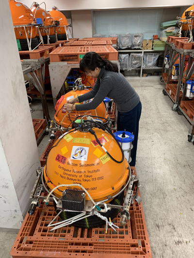 HyeJeong Kim helping to organize the ocean bottom seismometers that came back to the Earthquake Research Institute after the recovery of the Oldest-1 array in 2019.