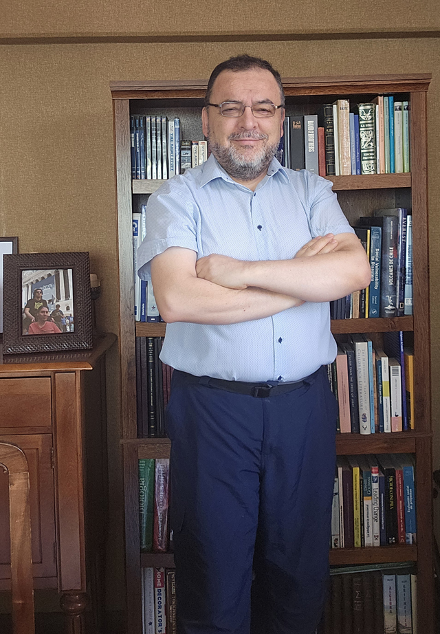 Luis Donoso Carmona standing in his office