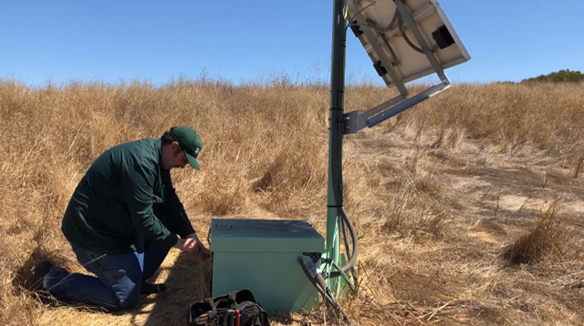 USGS researcher installing ShakeAlert sensor near San Francisco