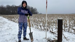 Kat Dapre retrieving seismometers in Maryland field.