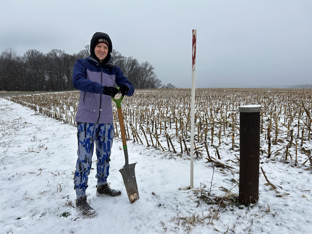 Kat Dapre retrieving seismometers in Maryland field.