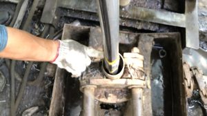 gloved hand pointing to Fiber optic deployment to borehole in Lantai