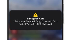 image of WEA ShakeAlert notification on phone screen, reading: “Earthquake Detected! Drop, Cover, Hold On. Protect Yourself. -USGS ShakeAlert”