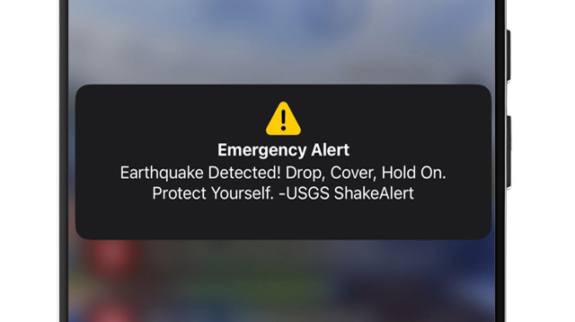 image of WEA ShakeAlert notification on phone screen, reading: “Earthquake Detected! Drop, Cover, Hold On. Protect Yourself. -USGS ShakeAlert”