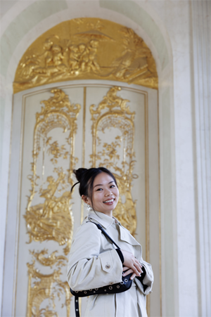 Irene Liou standing in front of gold door